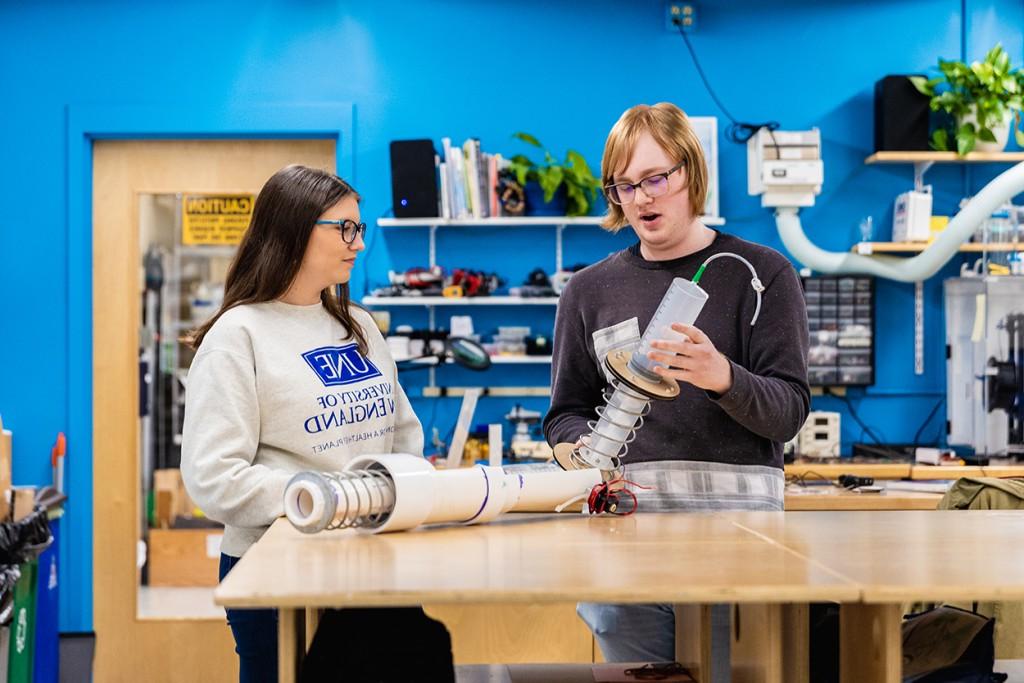 Two students discuss a project in the Makerspace
