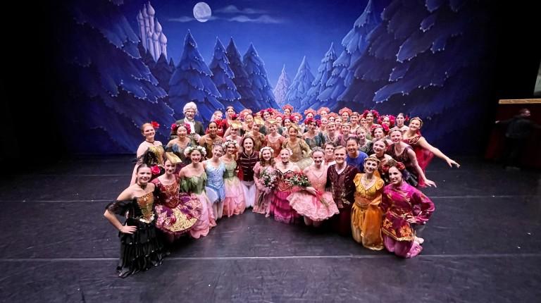 A cast of ballet dancers pose in costumes from "The Nutcracker"